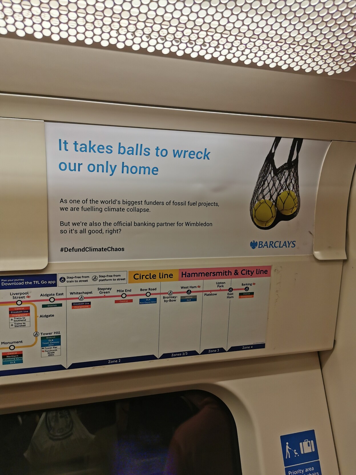 Advert on the London Underground. It says "It takes balls to wreck our only home" followed by "As one of the world's biggest funders of fossil fuels projects, we are fuelling climate collapse" followed by "But we're also the official banking partner for <br />Wimbledon so it's all good, right?" <a class=
