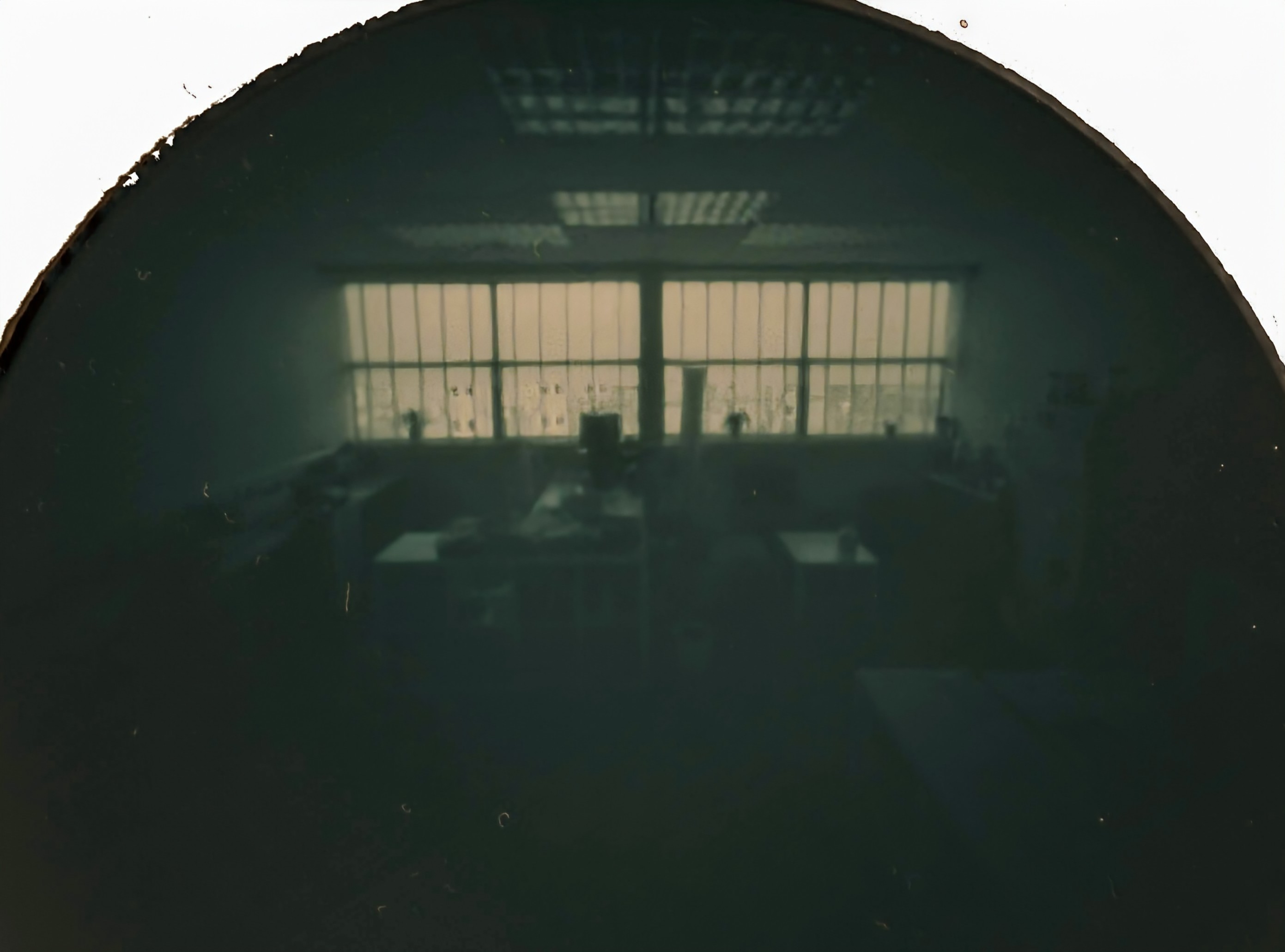 Semi-circular 'photo' using a pin hole camera and light sensitive paper.
Centre is a large rectangular window. Above it lights and below it desks.